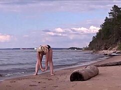 blonde babe charging at sea in costume.