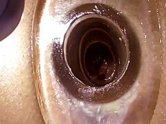 close up view of tight anal tunnel stretched by vibrator and dildo