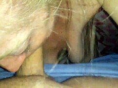 A petite blonde performs a blowjob.