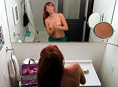 blonde lesbian bombshell sneaks into redhead’s place for a steamy shaved pussy session.