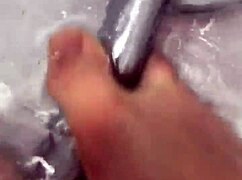 I slip off my nylon stockings and step into the shower for a footjob.