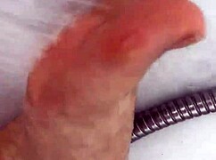 I slip off my nylon stockings and step into the shower for a footjob.