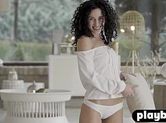 Amazing curly model performs solo striptease in front of the camera.