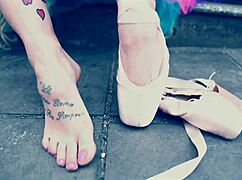 Ballerina strolls in ballet shoes on the street