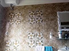 A woman with glasses experiences spanking in the dirty bathroom