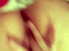 A redhead latina woman performs self-fingering in a private setting.