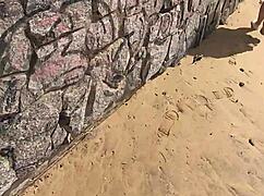 This young girl flashes her pussy on the public beach in a tiny thong bikini.