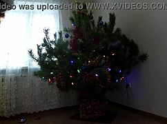 Teen bitch dances naked around the Christmas tree showing tits and ass