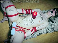 bound slave uses vibrator as a candlestick