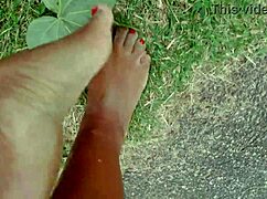 African pornstar walks barefoot on beach and street, dirtying feet.