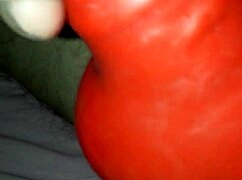 a husband tries on a latex suit with a sheath for his amateur costume.