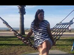 naked latina brunette girl bent over on public beach