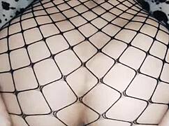 Wife rides in cowgirl position wearing mesh bodysuit.