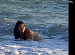 naked latina brunette girl bent over on public beach