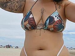 young african girl flashes on usa beach to attract attention