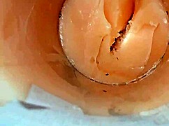 Camera deep inside tight pussy captures huge cum explosion, wet and shaved.