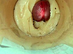 Camera deep inside tight pussy captures huge cum explosion, wet and shaved.