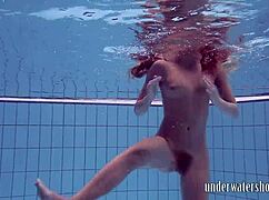 Lucy takes off her bikini in the pool, teasing underwater