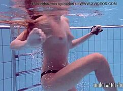 Lucy takes off her bikini in the pool, teasing underwater