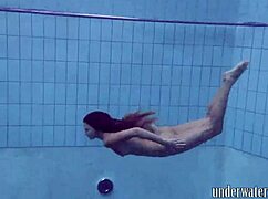 Lucy takes off her bikini in the pool, teasing underwater