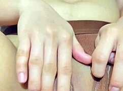 The beautiful Asian stepdaughter is spending some quiet time alone in her room, wearing shorts