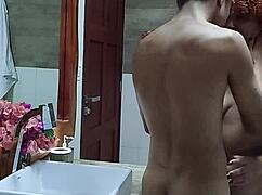 Young couple films amateur video in hotel bathroom.