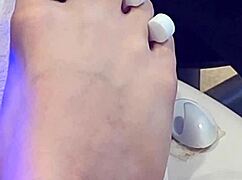 Shemale receives foot treatment.