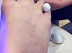 Shemale receives foot treatment.