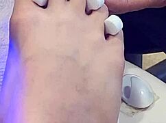 Shemale receives foot treatment.