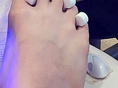 Shemale receives foot treatment.