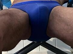 deep pelvic stretching in blue briefs on a blue chair during late october 2024