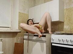 brunette amateur masturbates in kitchen with double banana penetration