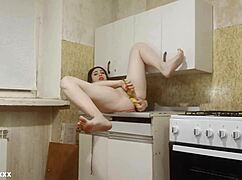 brunette amateur masturbates in kitchen with double banana penetration