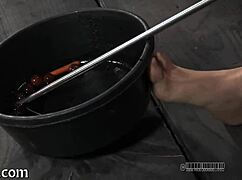 in a dark dungeon, a dominant master inflicts intense pain on his submissive slave during hardcore sadomasochism session