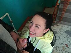 Brunette teen girlfriend sucks huge cock on public staircase swallowing cum mouthful