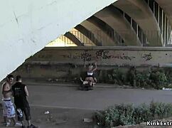 Bound blonde slut in latex endures bizarre outdoor bondage domination fuck.