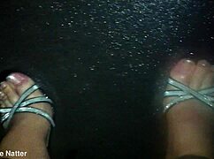 rain soaks sexy nylons and stilettos on wet outdoor strut