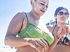 My slutty friend and I tease each other intimately on the crowded beach for all to see