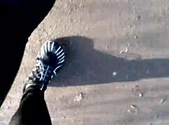 She tries on her new barefoot shoes outdoors