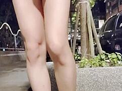 The crossdressing Taiwanese ladyboy flashes outdoors in flats then cums on legs