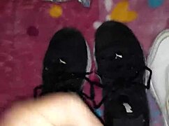 cumshot lands right on the tennis shoes in fetish play.