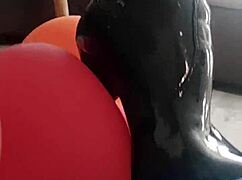 veve pops balloons sharp-style in shiny latex stockings hugging her big tits