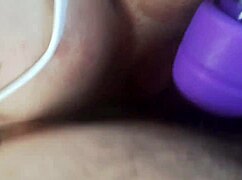 vintage blue film babe vibes her wet pussy close-up on retro toy.