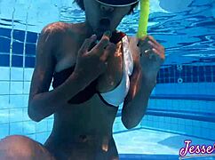 Petite Asian swims outdoors with buttplug gaping ass to mouth