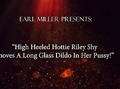 high heeled shy riley rams long glass dildo deep in shaved pussy to orgasm!!