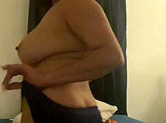 mature latina in glasses slowly strips clothes revealing her milf curves.