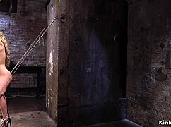 blonde bends back in dungeon hogtie bondage
