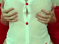 Don't you love watching this pretty blonde tease her huge silicone tits through a see-through dress up close?