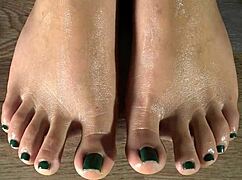 CLOSE UP on oiled Colombian feet massage fingering green nails taboo tease
