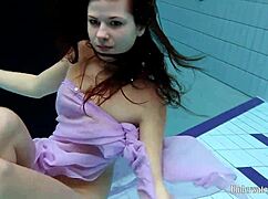 Aneta squeezes big tits in purple dress underwater pool tease